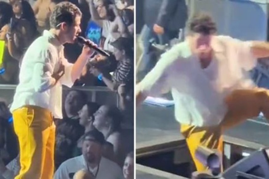 Nick Jonas falls through hole during performance